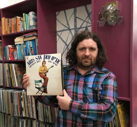 DJ Fitz holding a record from his collection