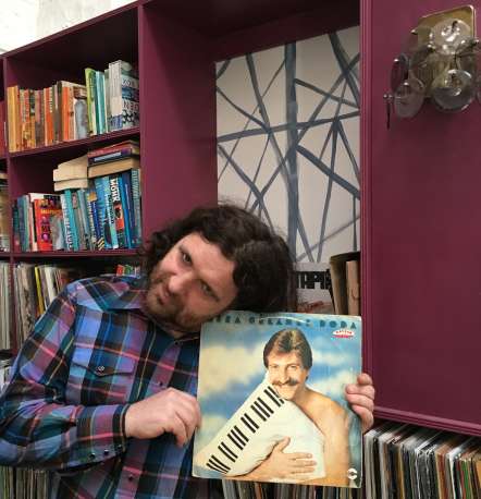 DJ Fitz holding a record from his collection
