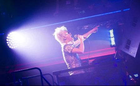 A DJ hypes up the audience at Club Millennium.
